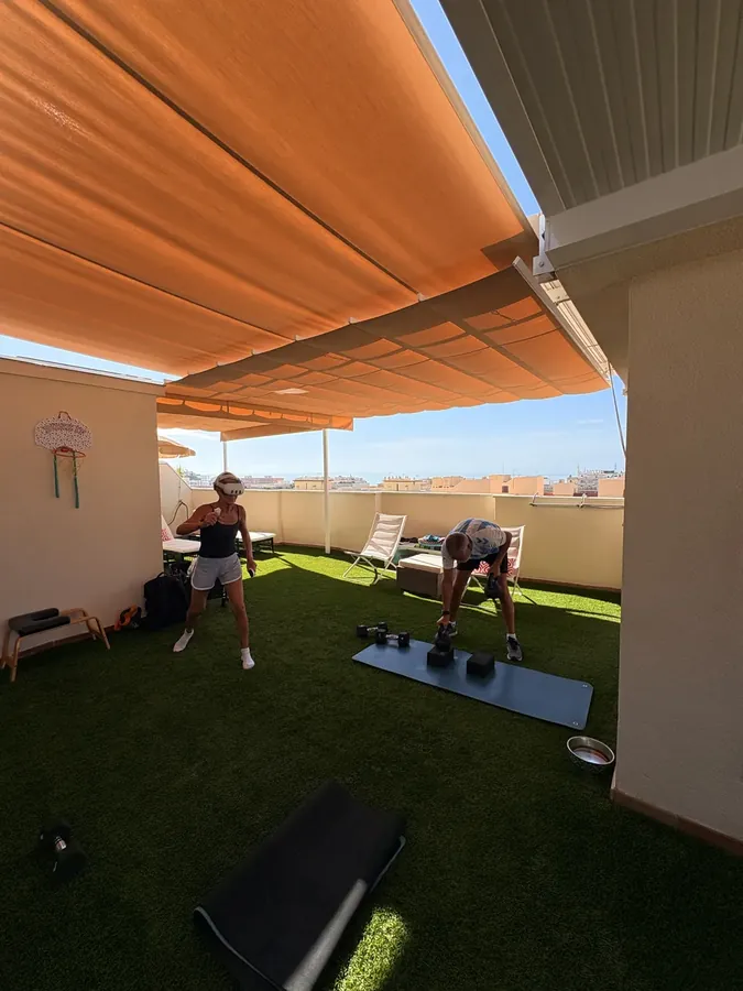 Couple training on a sunny terrace in Málaga